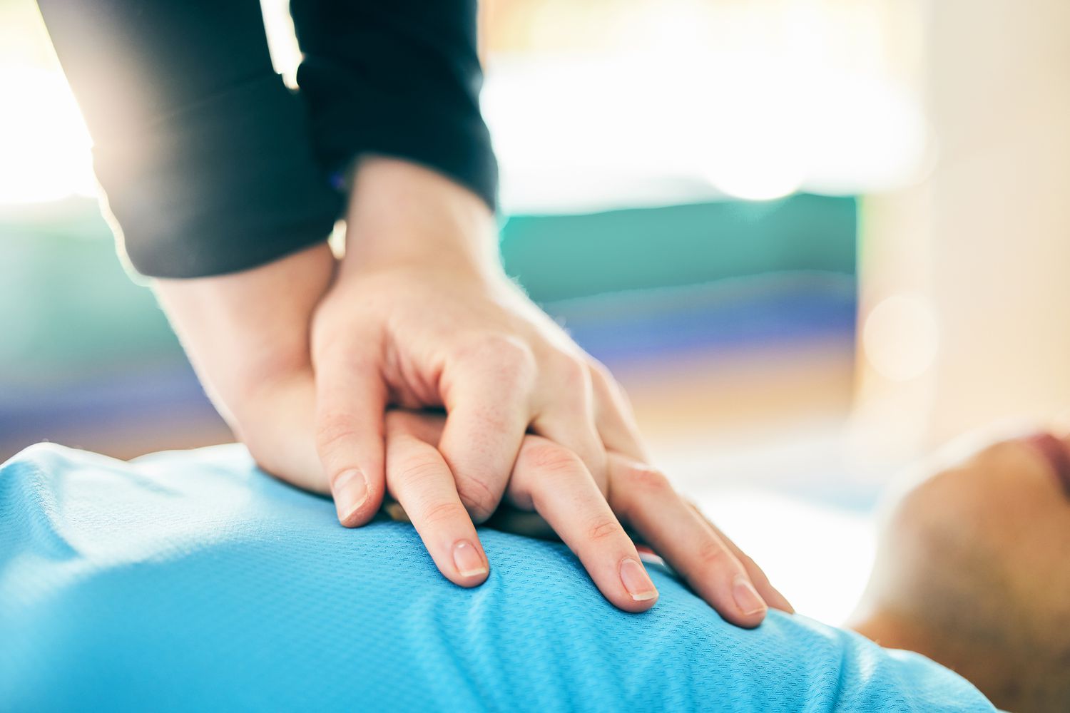 Hands performing chest compressions during CPR